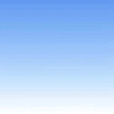 A completely clear blue sky extending across the entire image. The blue hue varies from a lighter shade near the horizon to a deeper, richer tone at the zenith. There are no clouds visible in the sky, creating a vast, uninterrupted expanse. The sunlight bathes the scene in a bright illumination, enhancing the clarity of the blue.