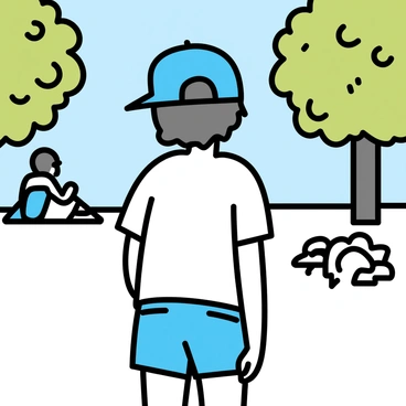 A person wearing a baseball cap backwards in a casual outdoor setting