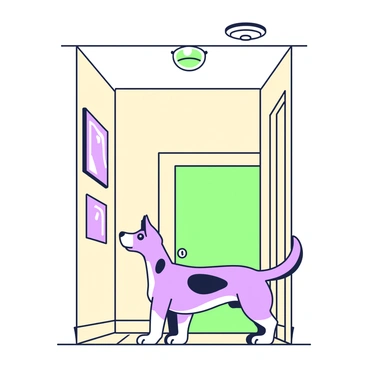 A curious dog is standing on its hind legs in a hallway, looking up at a smoke detector mounted on the ceiling. The dog has a shiny coat with distinct markings, and its ears are perked up attentively. The hallway features beige walls and a wooden floor, with a light fixture visible in the background. The smoke detector is round and white, clearly positioned above the inquisitive dog. A few framed pictures hang on the wall beside the hallway, adding to the domestic atmosphere.