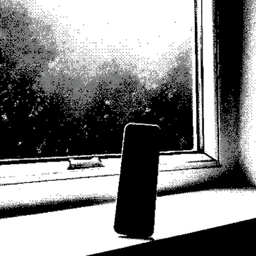 A flip phone is placed on a windowsill, the surface of the phone reflecting the light from the outside. The phone is closed, displaying its sleek design. Raindrops are gently falling on the windowpane, creating small streaks as they travel down. The window is framed with white trim, and blurred outlines of greenery can be seen outside, obscured by the rain. The atmosphere conveys a sense of quiet and calm, highlighted by the soft, rhythmic sound of rain.