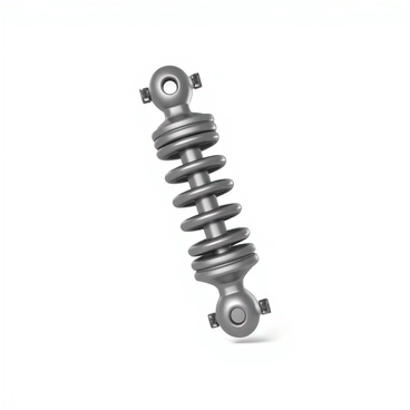 A car shock absorber with a metallic body, prominently showcasing its components. The spring is fully extended, revealing its coiled structure, which is made of high-tensile steel with a shiny finish. The shock absorber features mounting points at both ends, with a rubber bushing visible at the top. The surface of the absorber is smooth and reflects light, highlighting its mechanical design. The overall composition emphasizes the tension of the extended spring and the robust construction of the shock absorber.